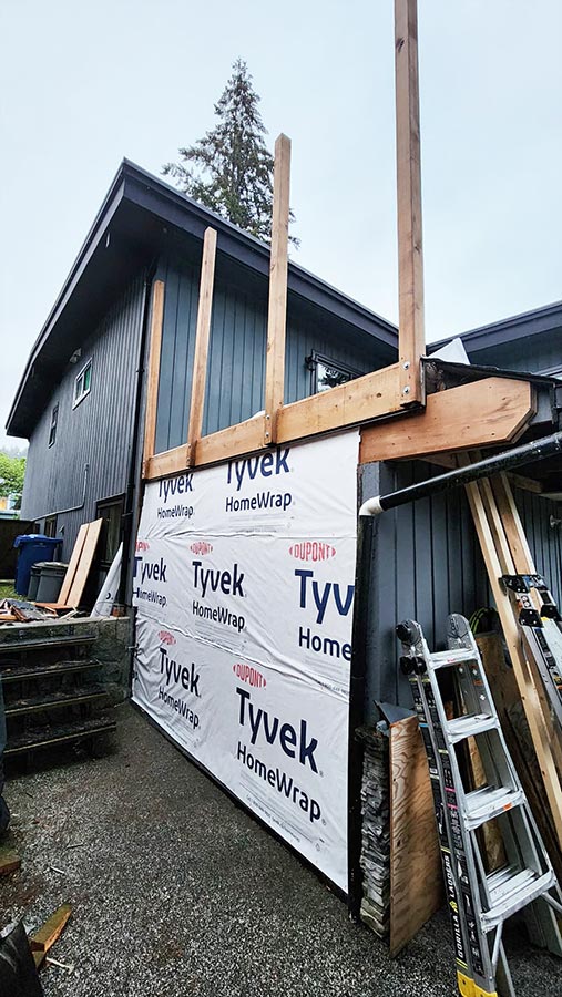 After shot of deck and wall repair with new wood, new insulation and tvyek wrap