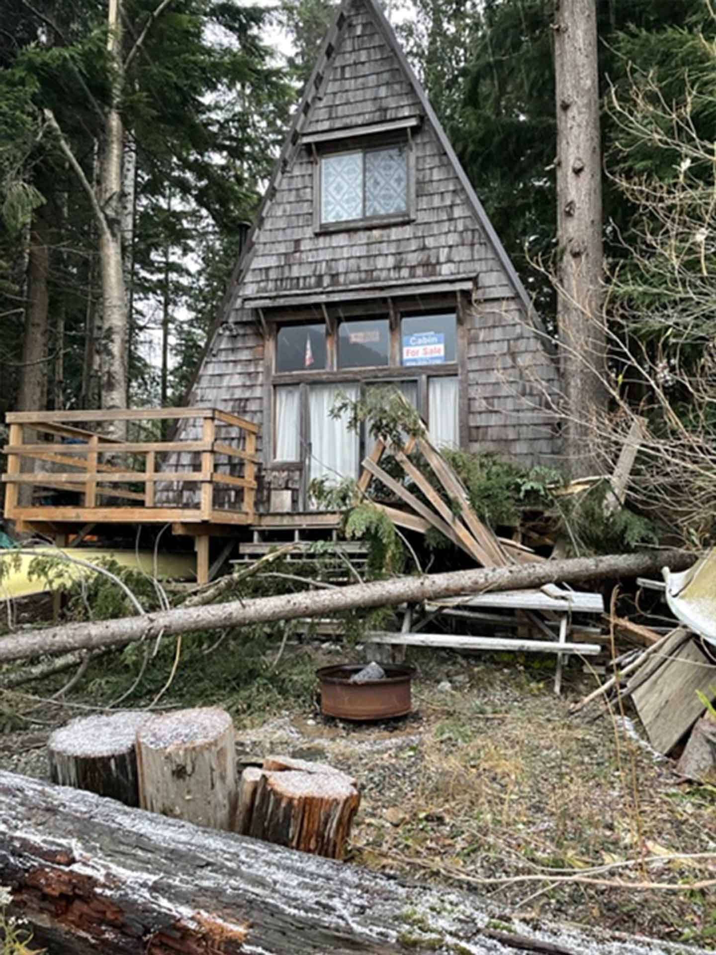 Broken deck and fence destroyed at a vacation home from a fallen tree