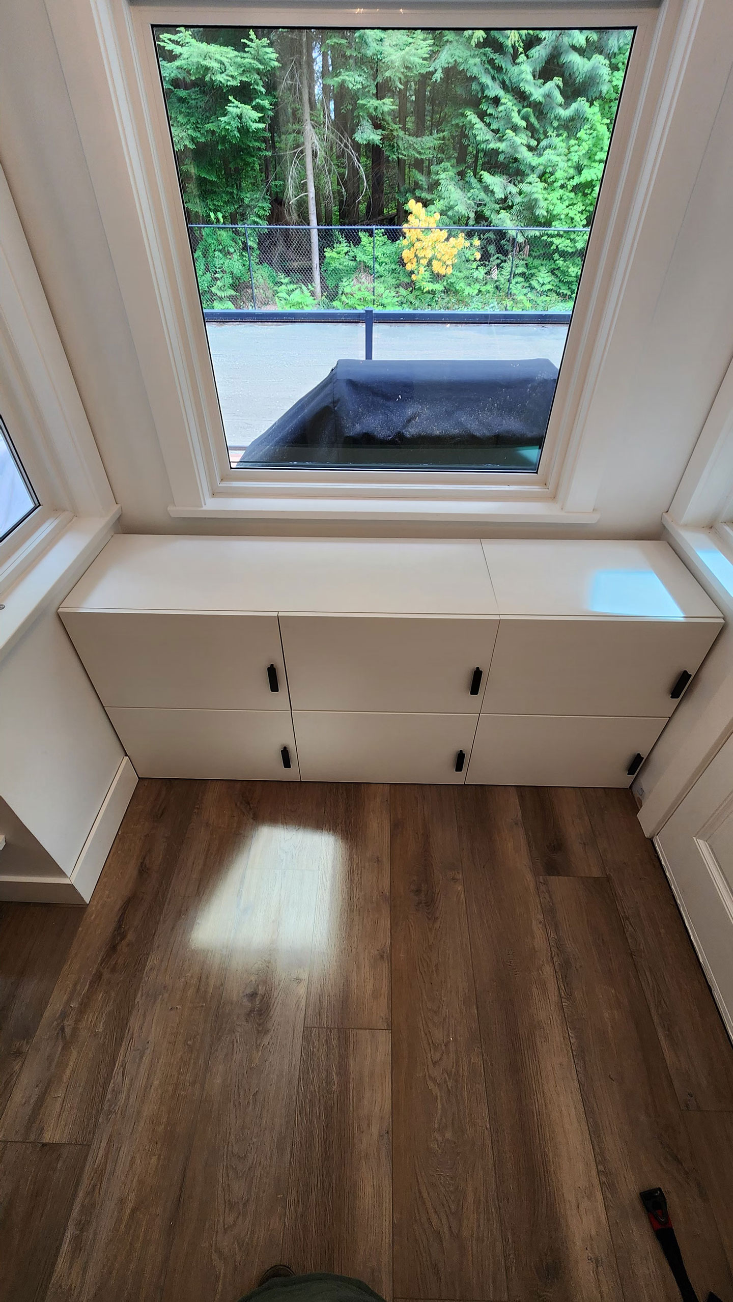 After shot of furniture assembly and installation in front of the window