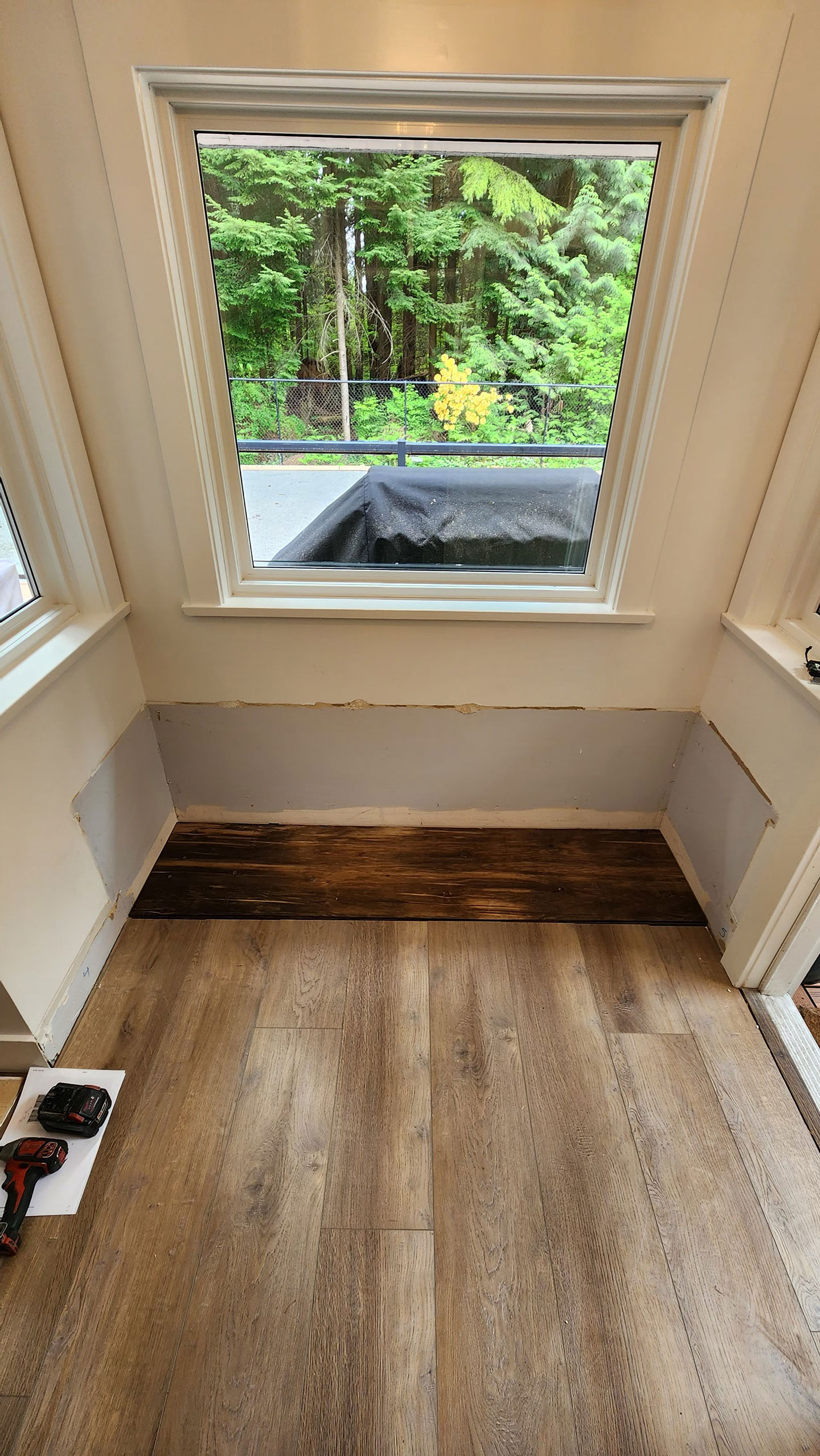 Before shot of furniture assembly and installation in front of the window