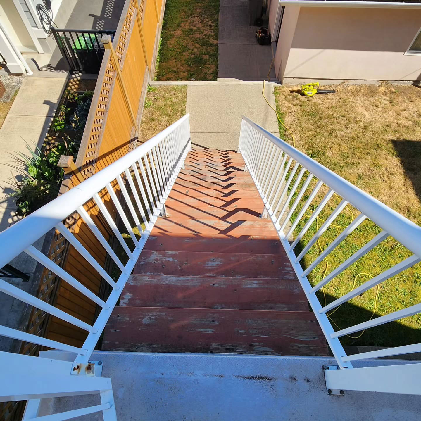 Faded paint on the red stairs in the back yard